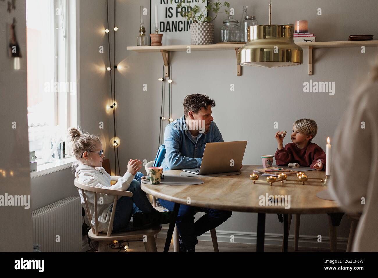 Father sitting with children at table Stock Photo