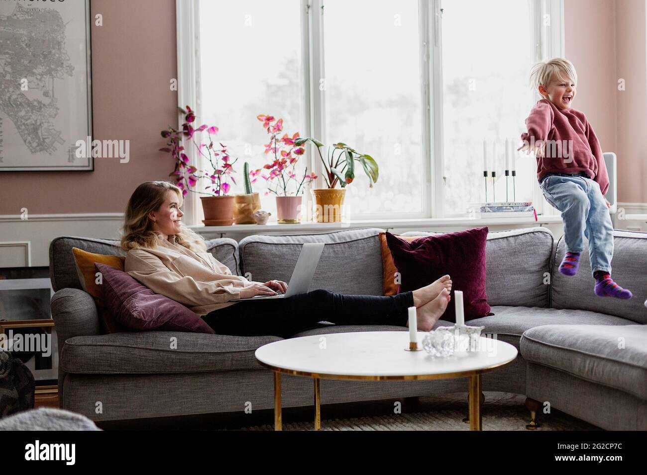 Mother with son on sofa Stock Photo