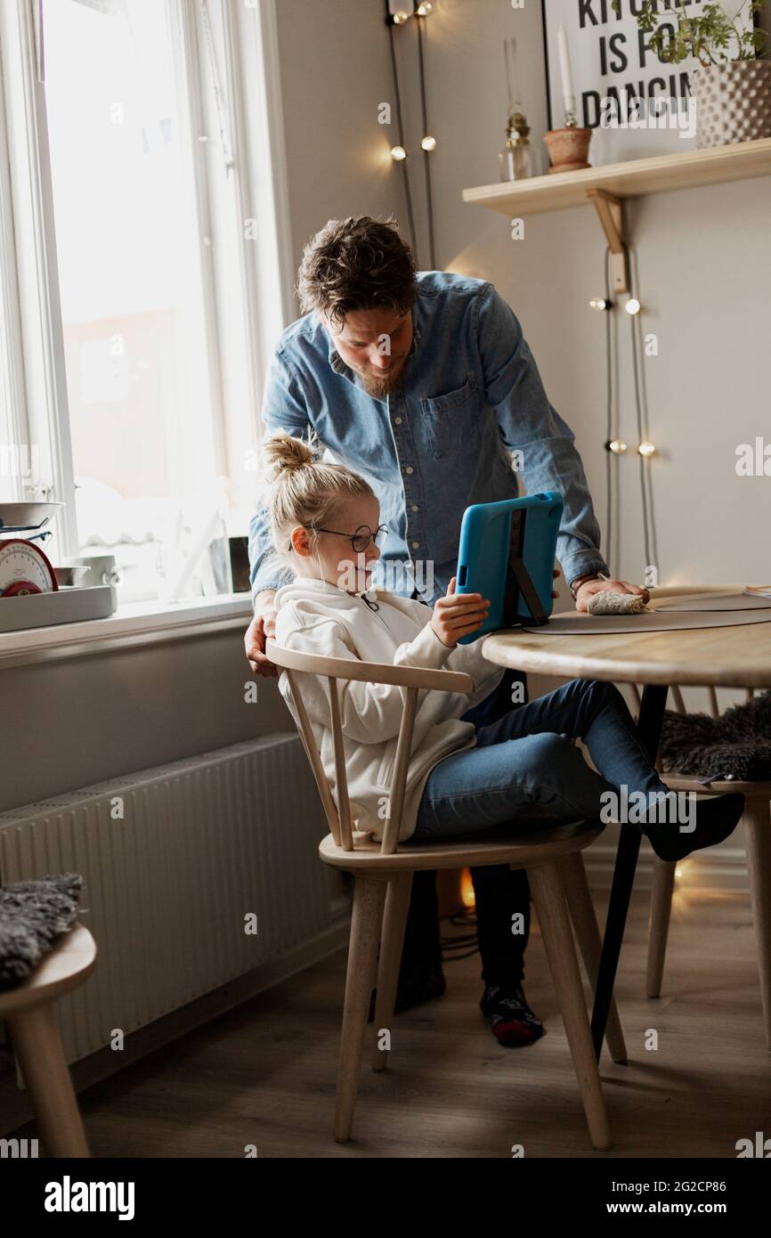 Father with daughter using digital tablet Stock Photo
