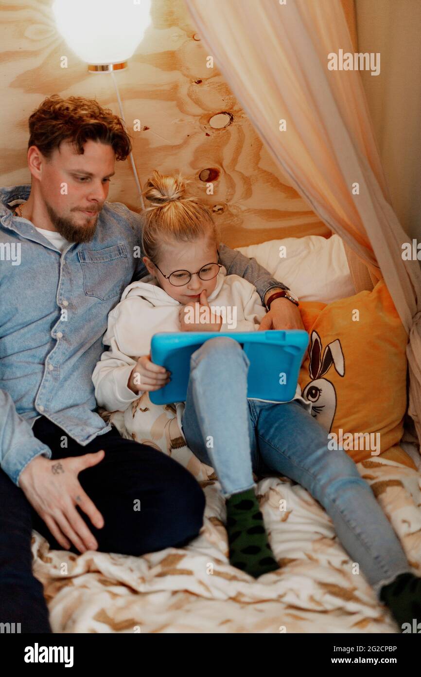 Father with daughter using digital tablet Stock Photo