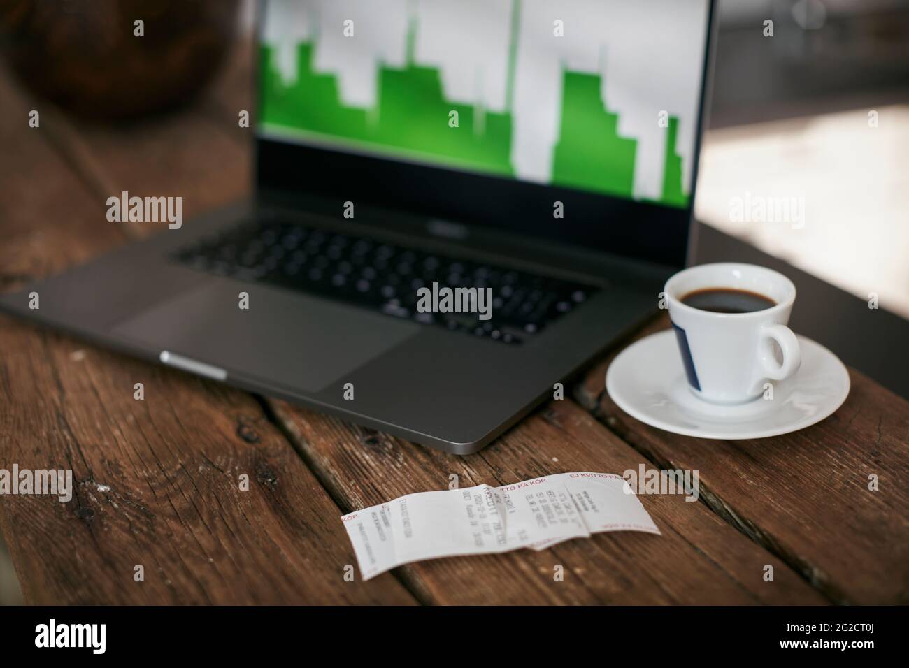 Receipt and coffee cup on worktop Stock Photo