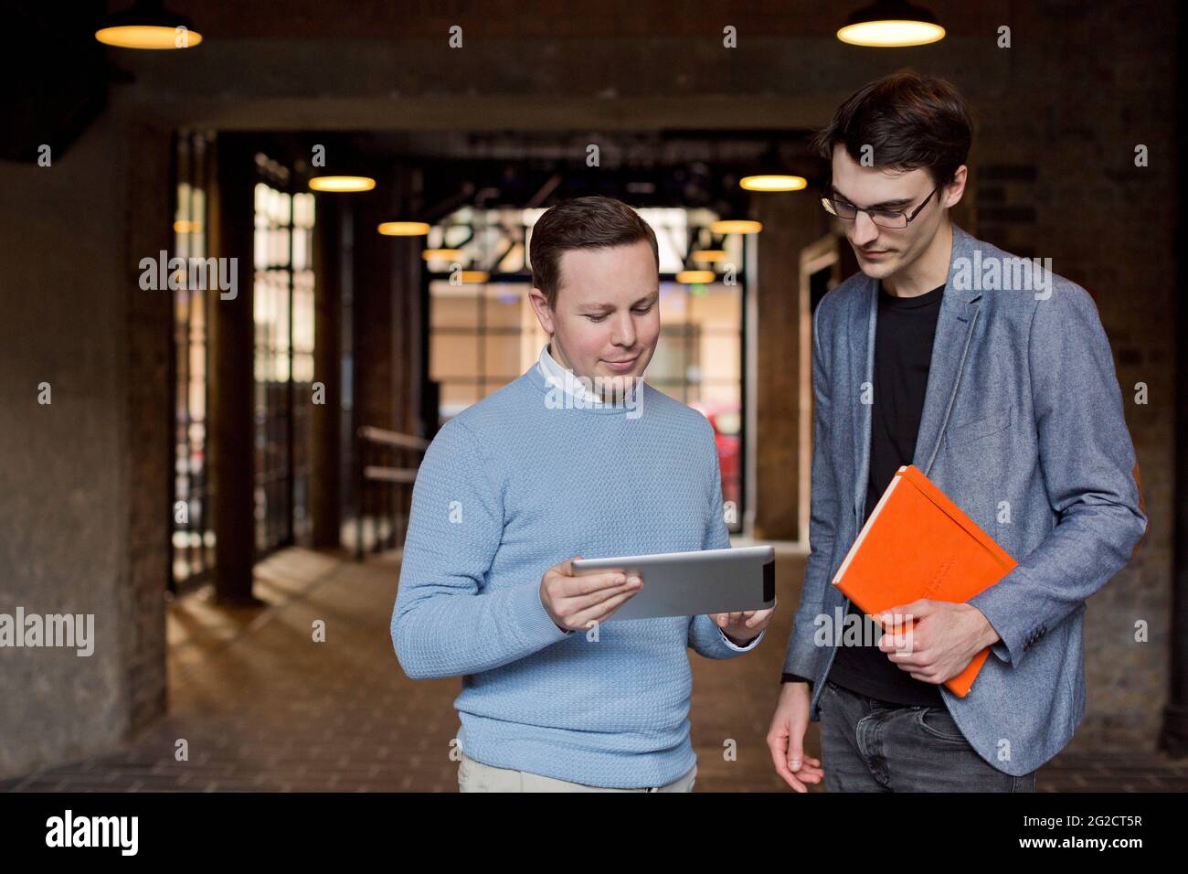 Businessmen standing outdoors and using tablet Stock Photo