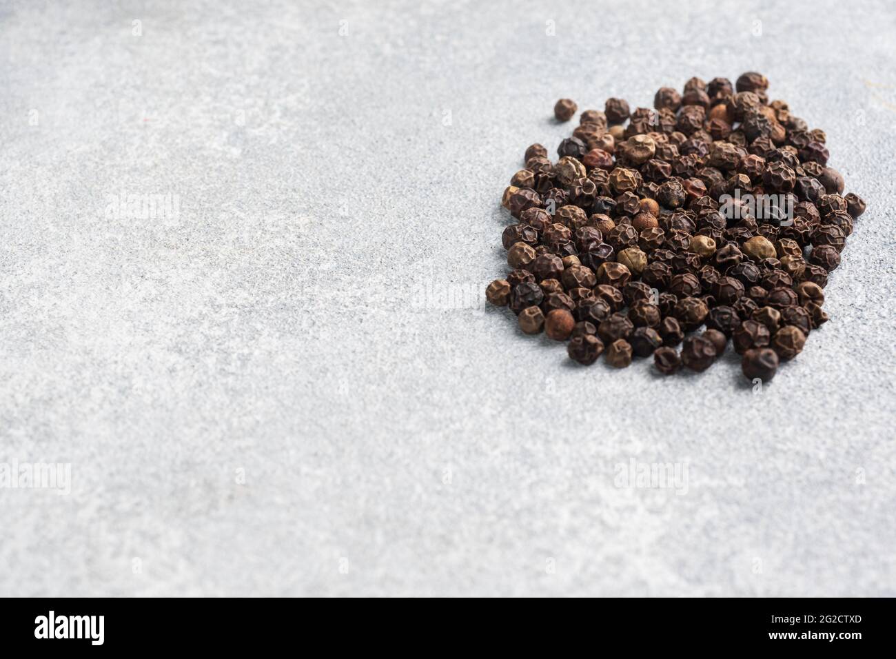 Black pepper peas on a gray concrete background, copy space Stock Photo