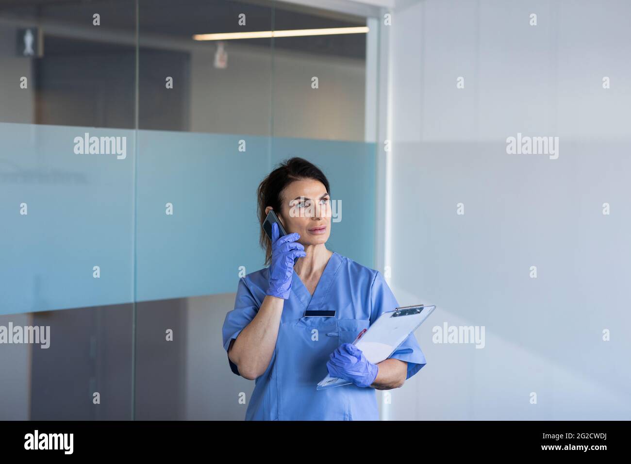 Female nurse talking on phone Stock Photo
