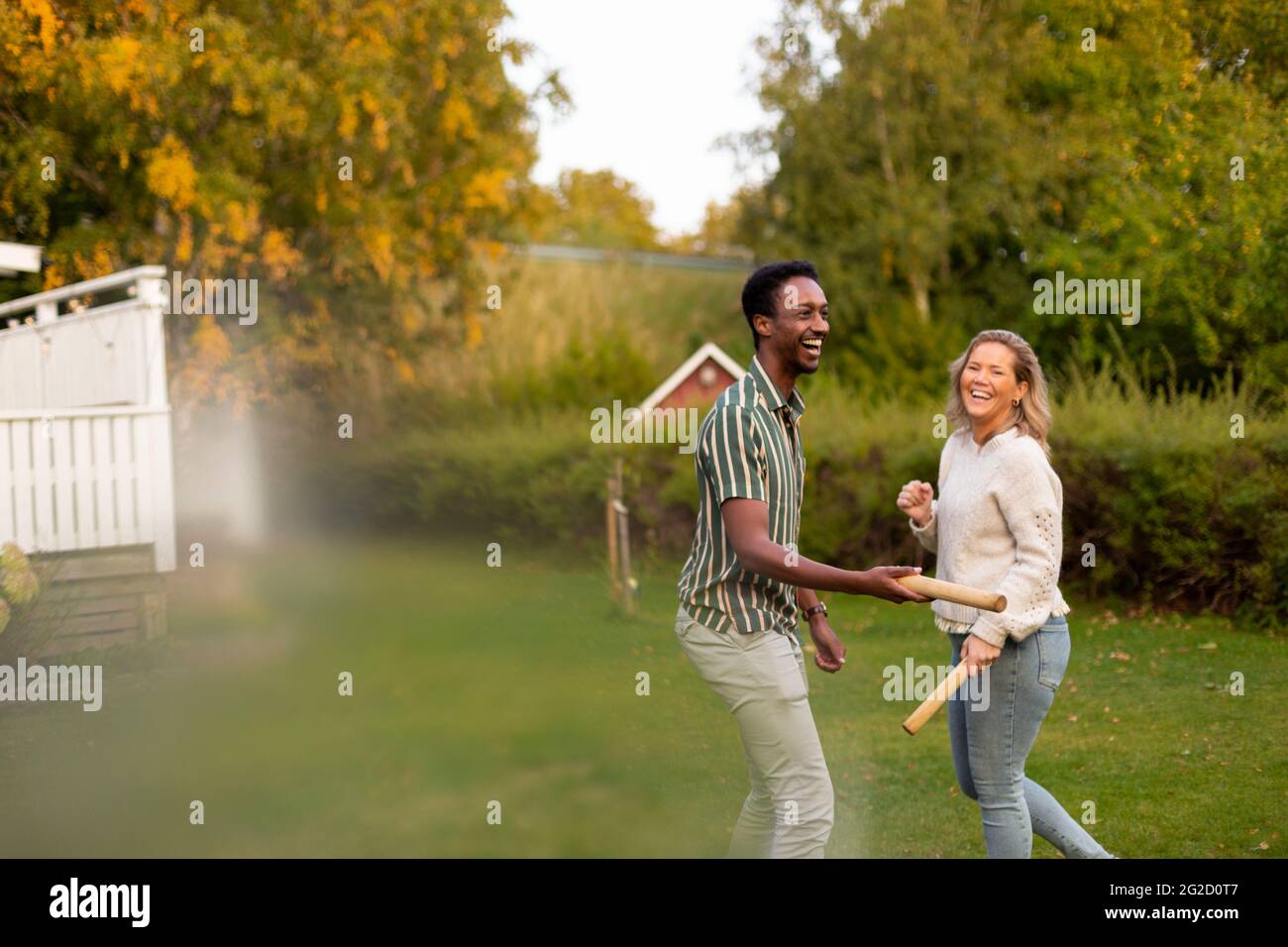 Man and woman playing molkky game in park Stock Photo