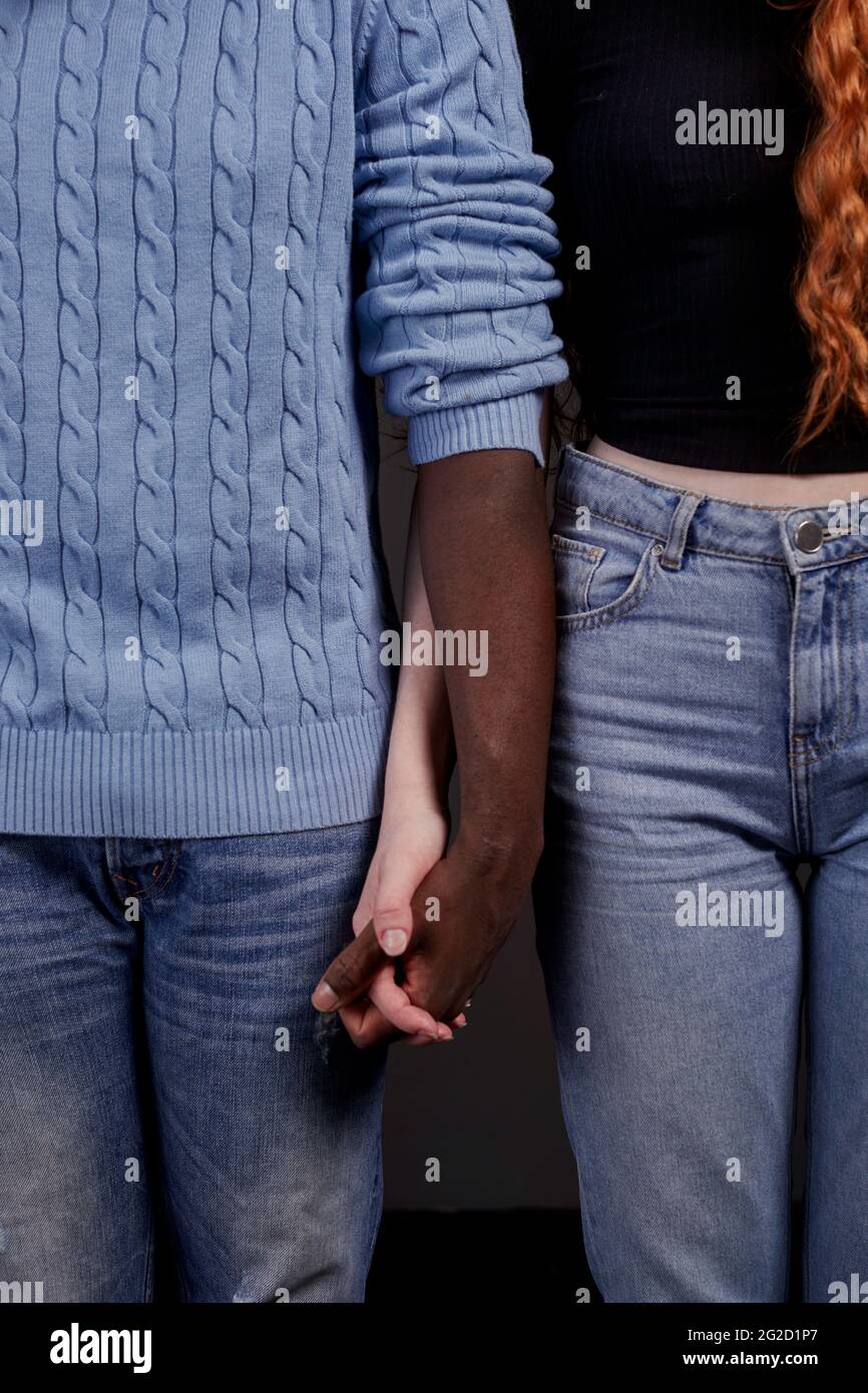Mid section of couple holding hands Stock Photo