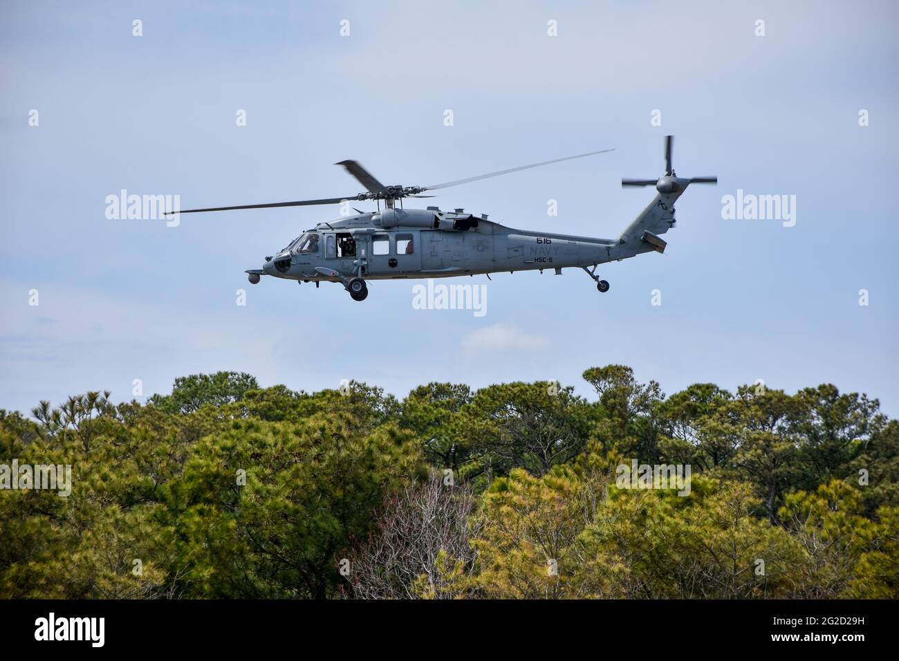A U.S. Navy Helicopter flying over the coast of North Carolina. Stock Photo