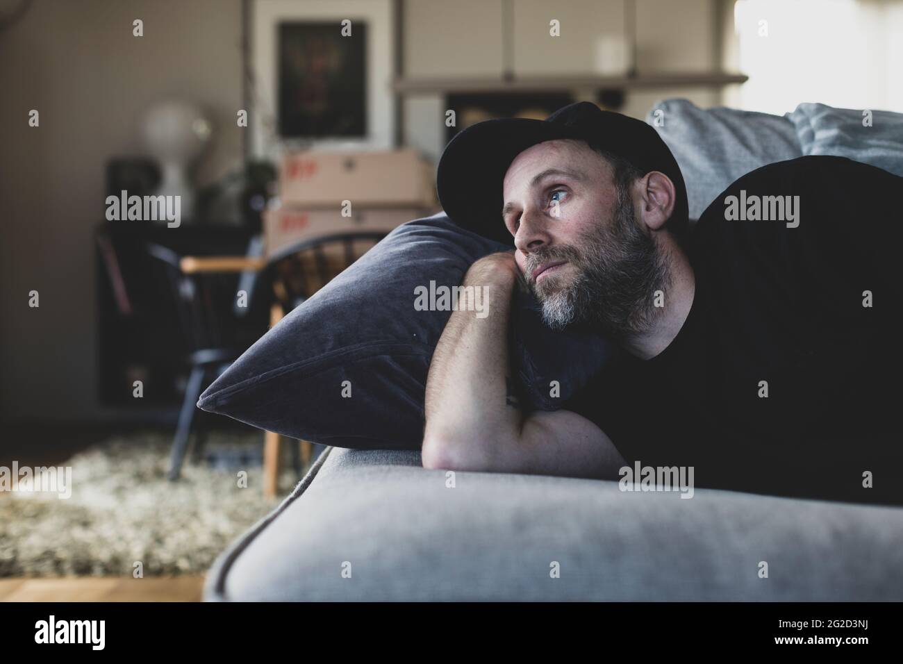 Mature man lying on sofa Stock Photo
