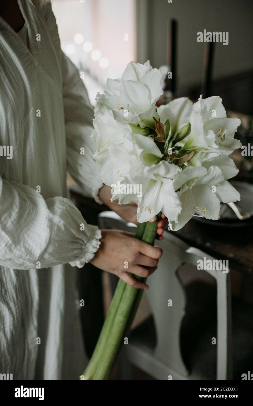 Woman holding bouquet of white flowers Stock Photo