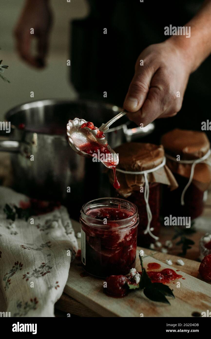 Man pouring homemade jam into jar Stock Photo Alamy