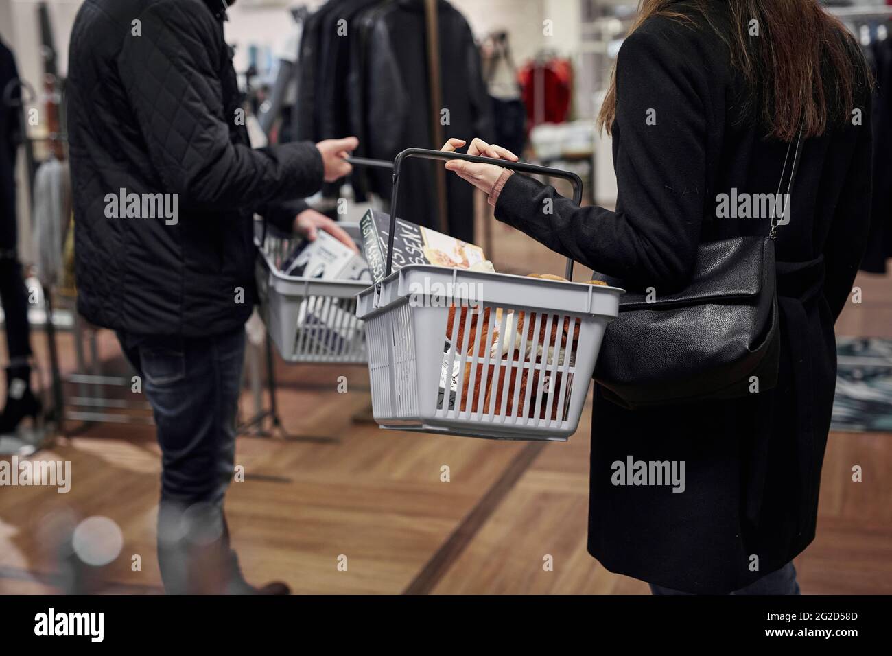 Man and woman with shopping baskets Stock Photo