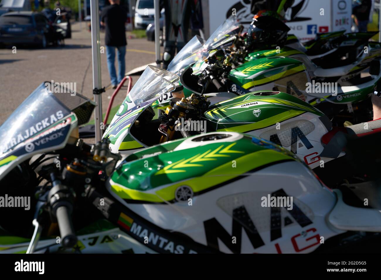 Row of motorcycles parked on a street in front a motorcycle store Stock Photo