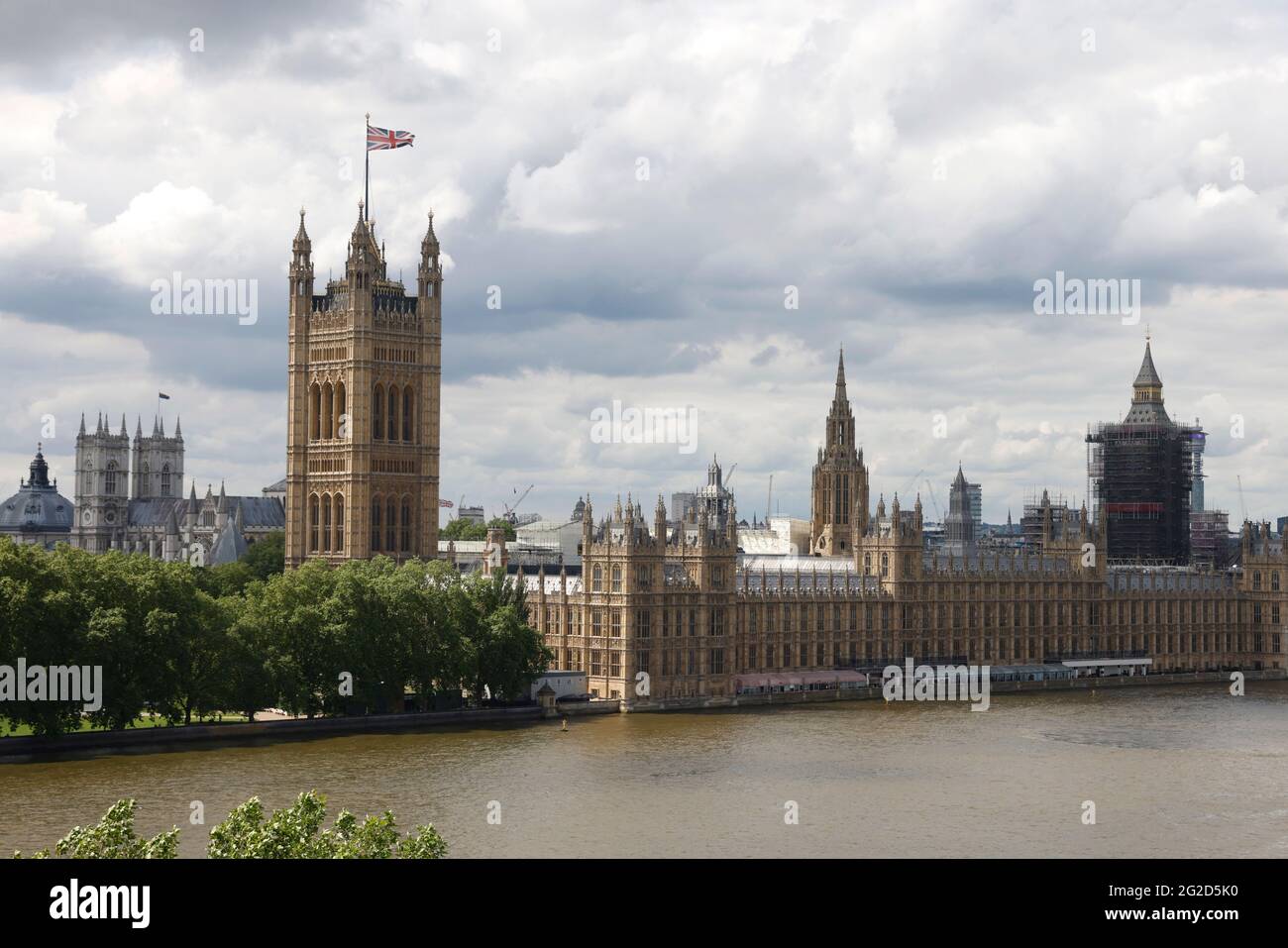 View of the River Thames and the Houses of Parliament including the Elizabeth Tower also known as Big Ben under scaffolding. Stock Photo