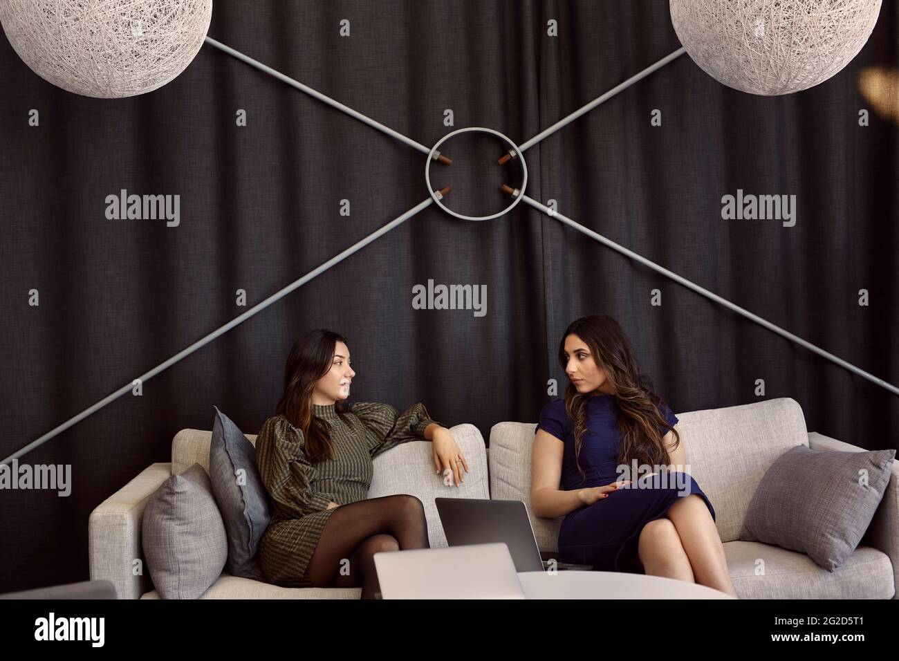 Businesswomen talking on sofa Stock Photo
