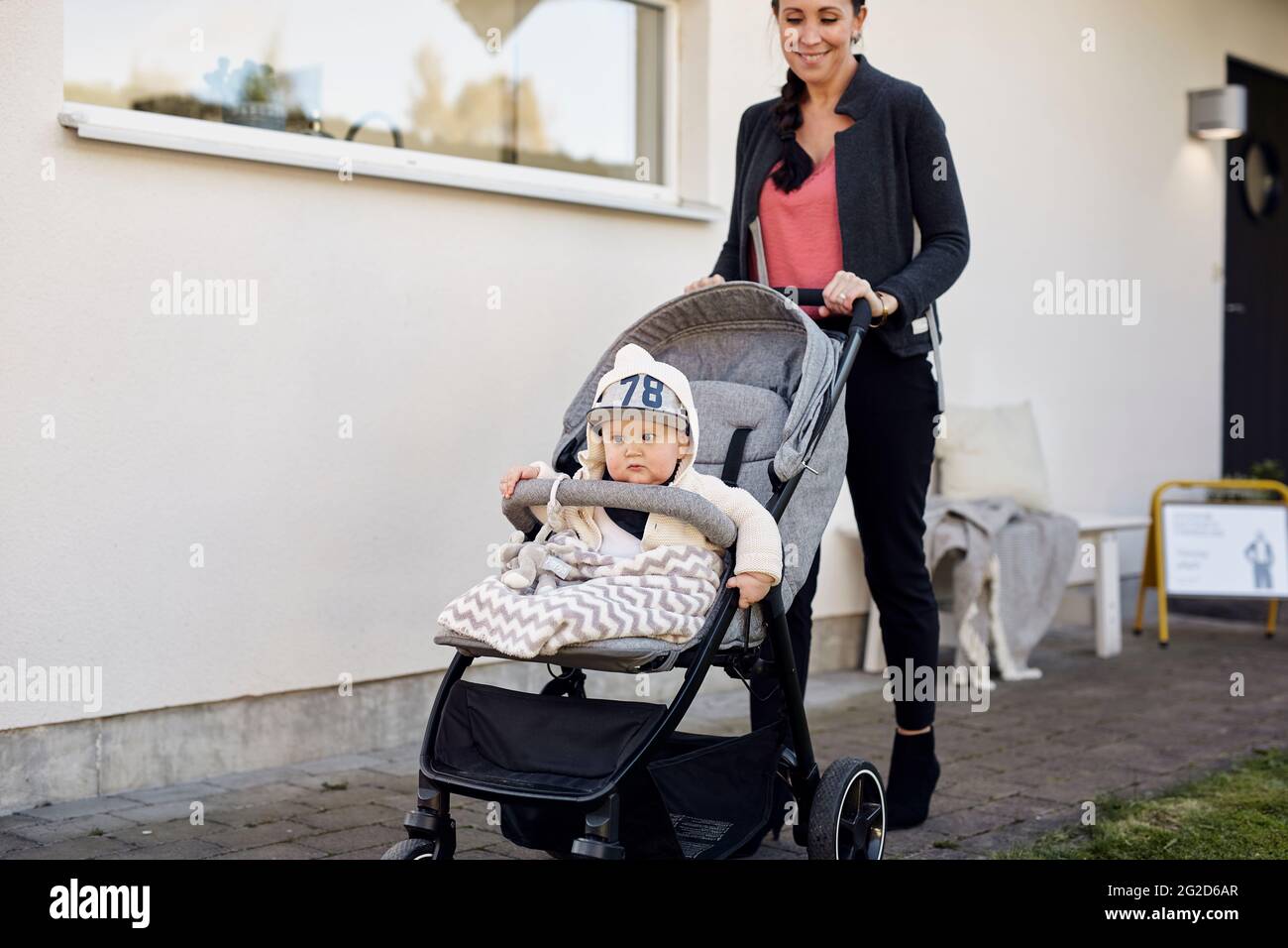 Woman Pushing Pram With Baby Son Stock Photo Alamy