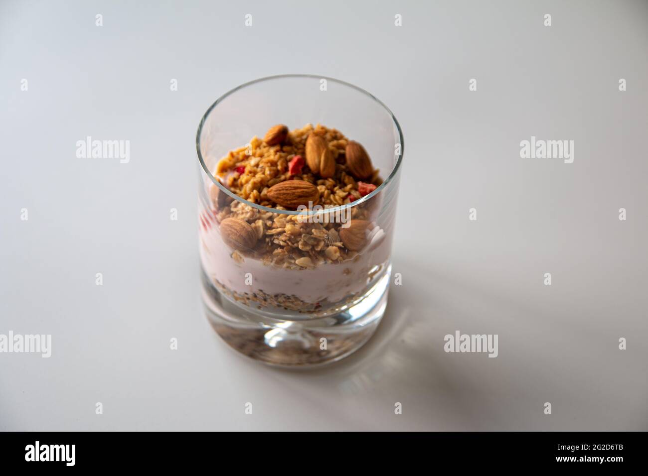 Healthy yoghurt photo with granola and almond, diet fresh yogurt with dried nuts and cereal, Light diet breakfast food with muesli Stock Photo