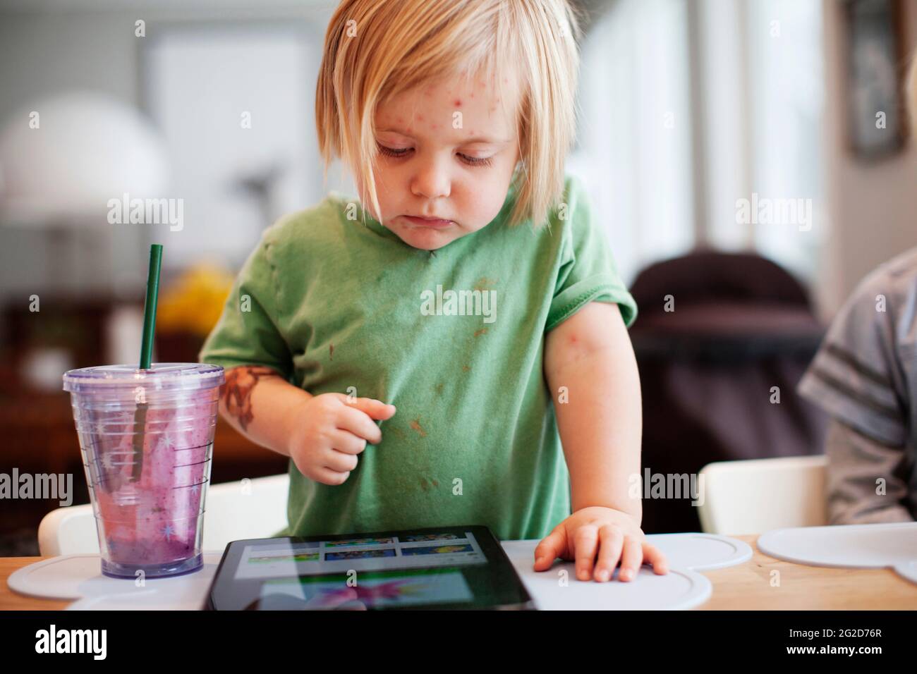 Girl playing with digital tablet Stock Photo
