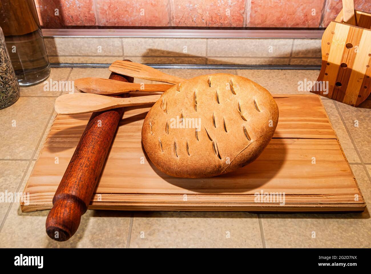 delicious freshly baked artisan bread, nutritious, homemade, fresh and healthy wheat flour, on a wooden board, top view close up. Stock Photo