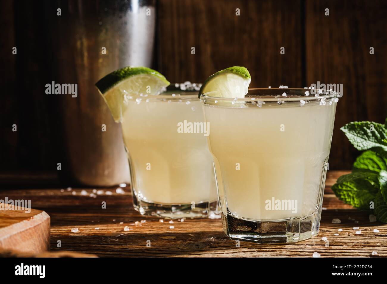 Cocktail With Salt Rim Margarita cocktail in drinking glasses with salt rim on rustic wood ...