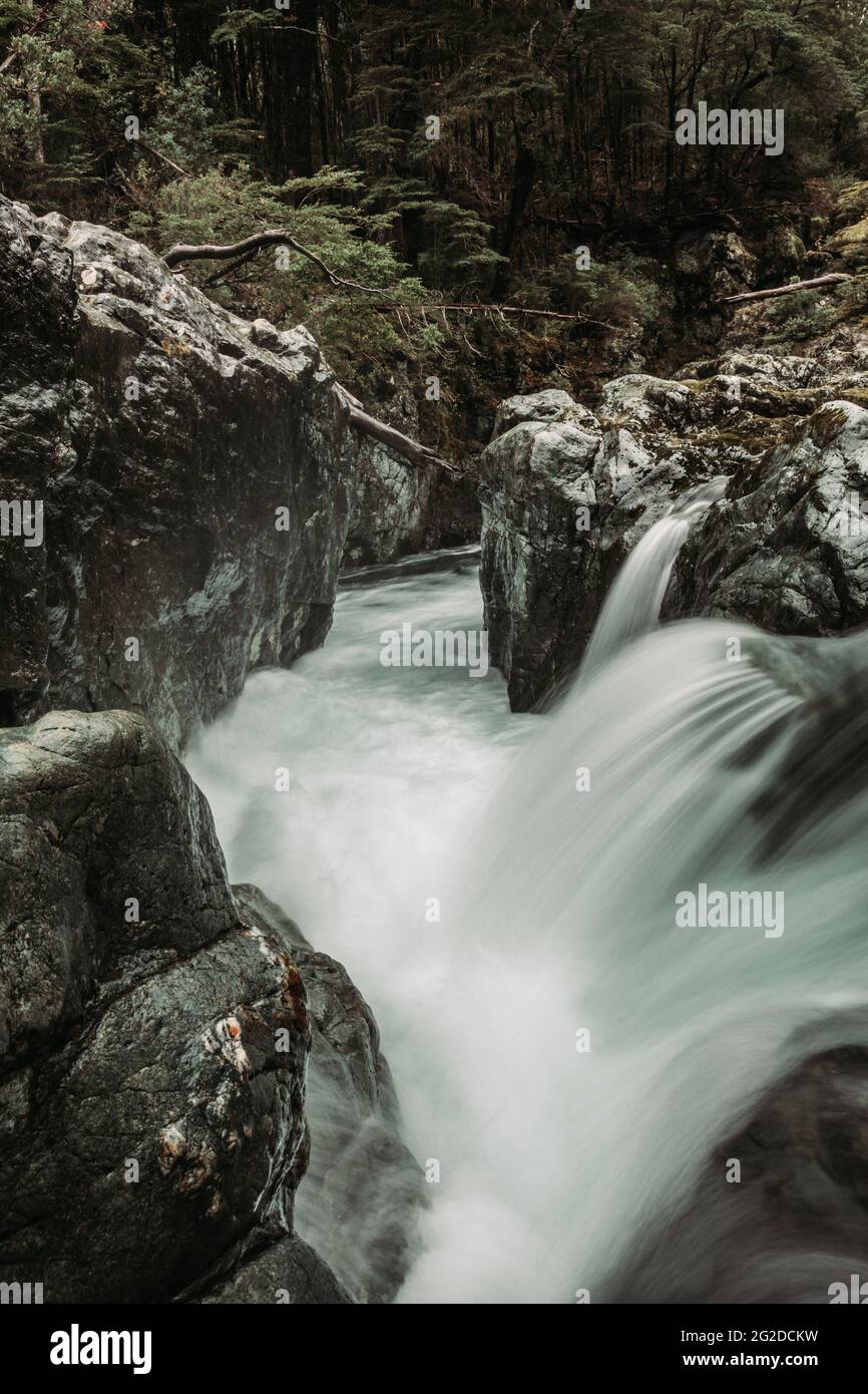 Long exposure shot of a waterfall flowing through the rocks in the ...