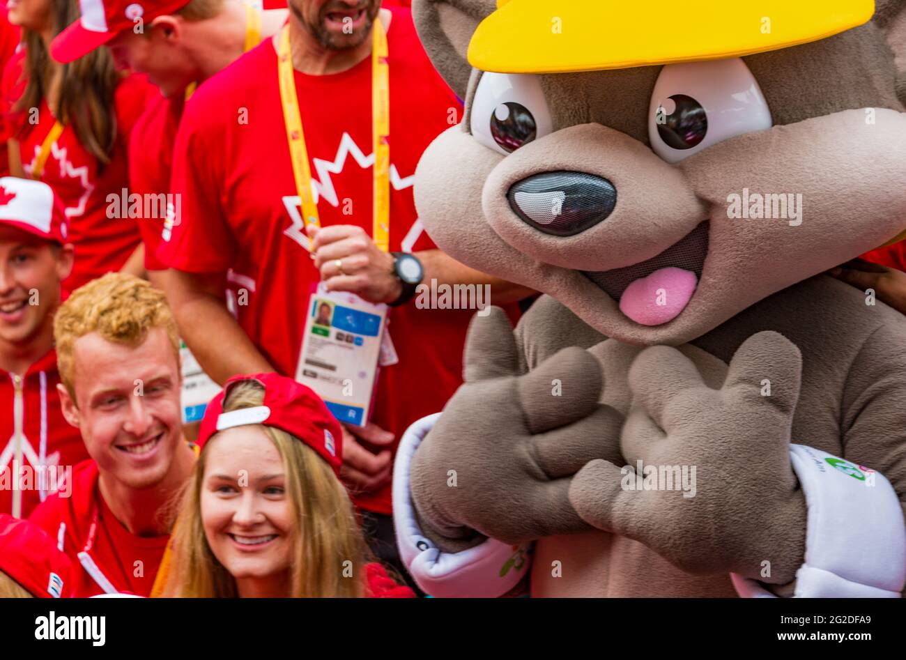 Closeup of mascot, Pachi the Porcupine with Canadian athletes in the background, at the 2015 Pan Am Games, Toronto. Pan-Am Games were a major internat Stock Photo