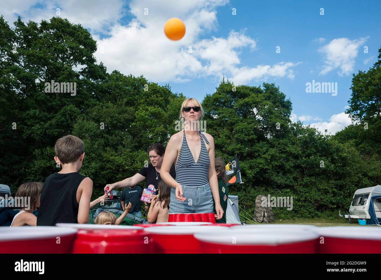 Playing beer pong on a camping trip with friends and family Stock Photo
