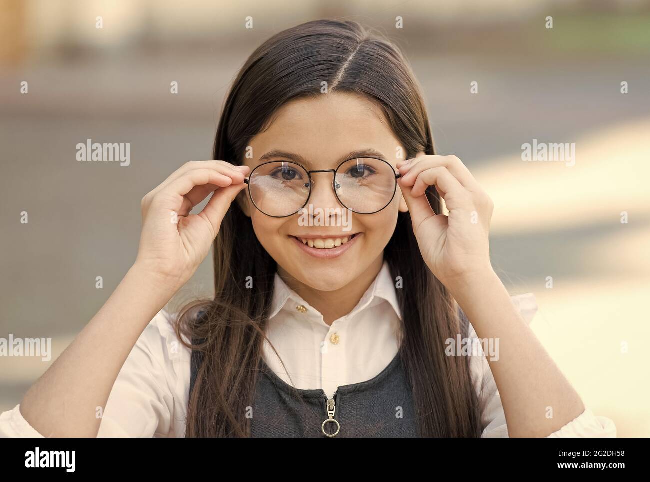 An intellectual look. Happy child look through glasses outdoors. Vision screening at school. Eye test. Corrective glasses. Prescription eyewear. Eye Stock Photo