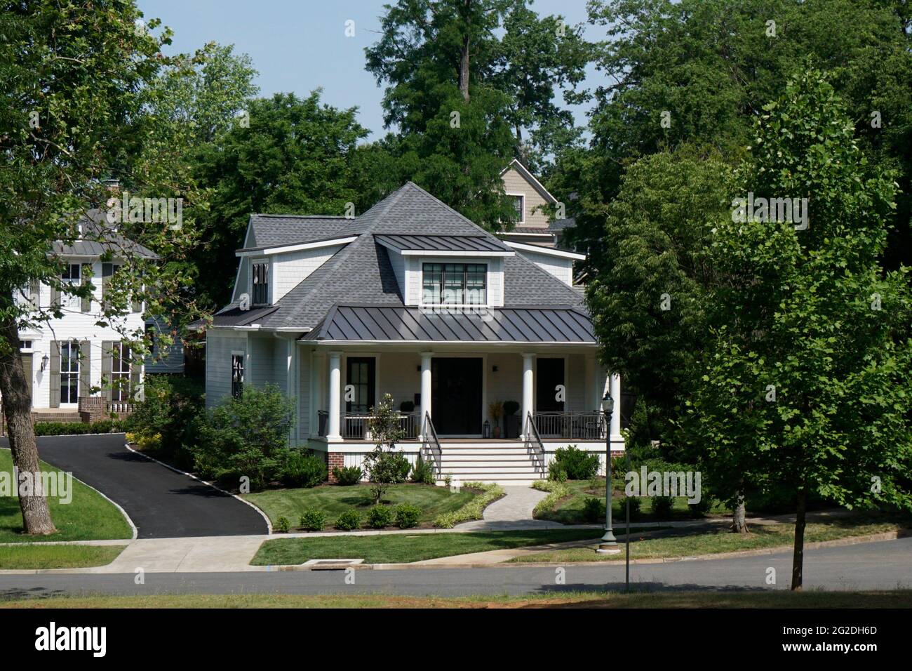 Street view of a house with a big porch in an urban neighborhood Stock ...
