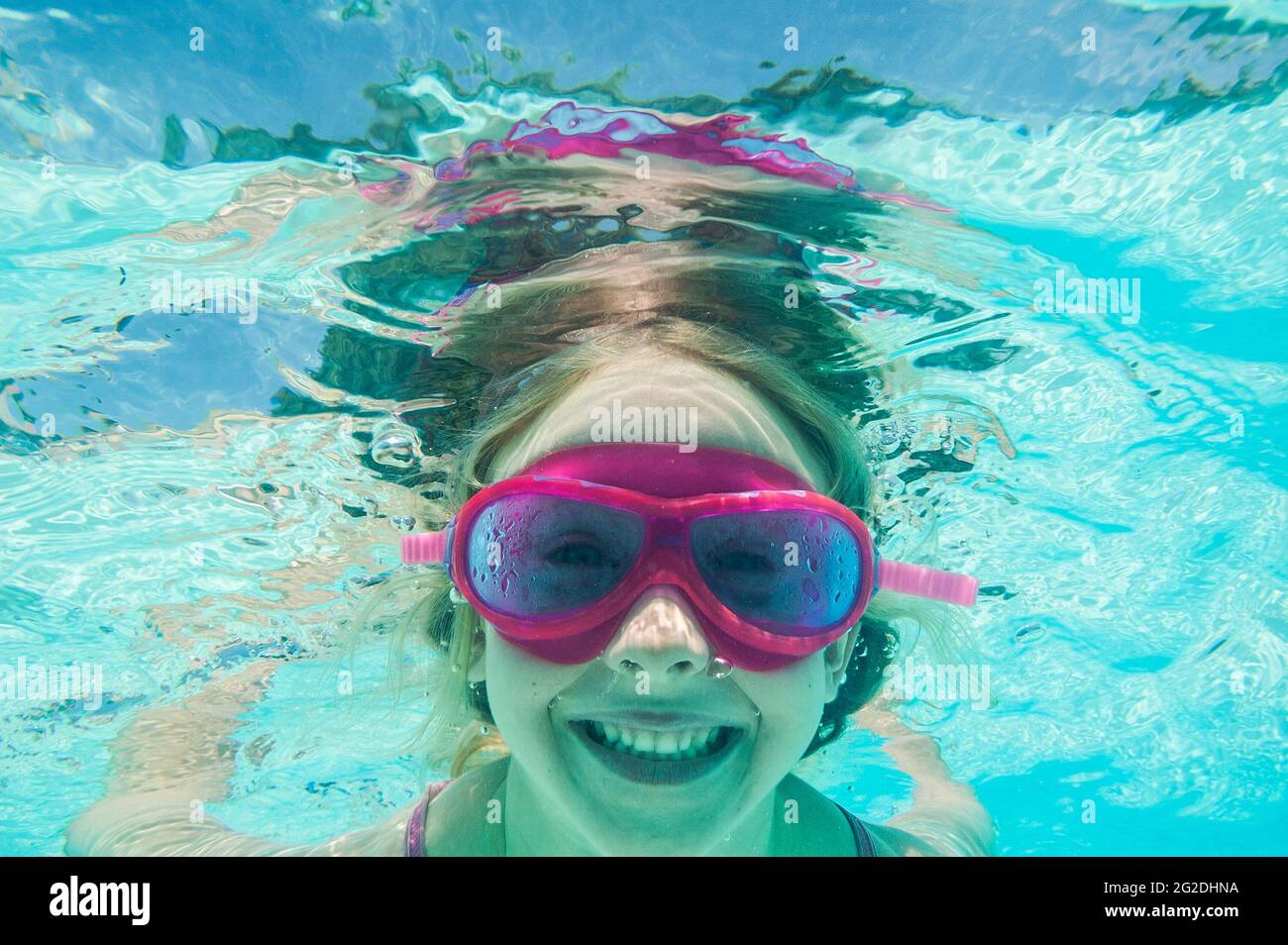 A person underwater enjoying them selves in a swimming pool. Stock Photo