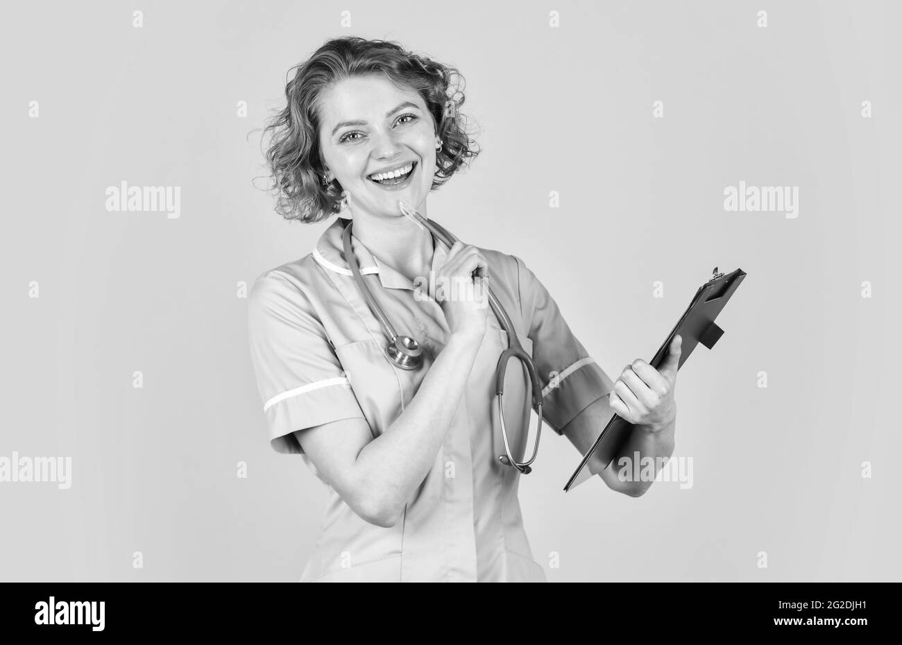 Great news for you. medical doctor holding a folder. nurse holding patient medical chart. Nurse holding folder and taking notes. folder of information Stock Photo