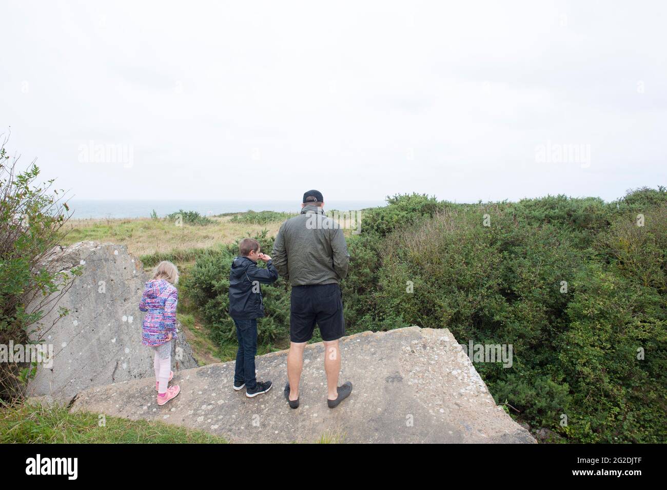 A family exploring the D Day sights of Normandy and learning about the history. Stock Photo