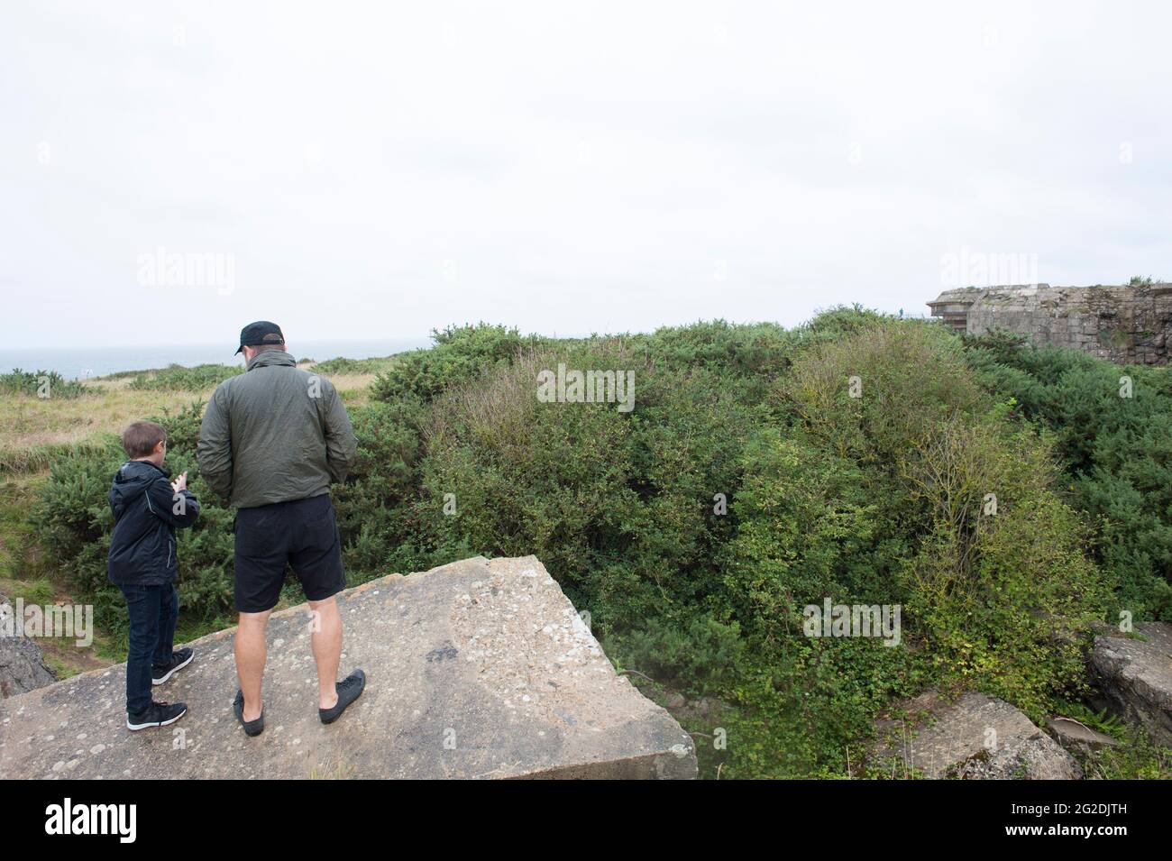 A family exploring the D Day sights of Normandy and learning about the history. Stock Photo