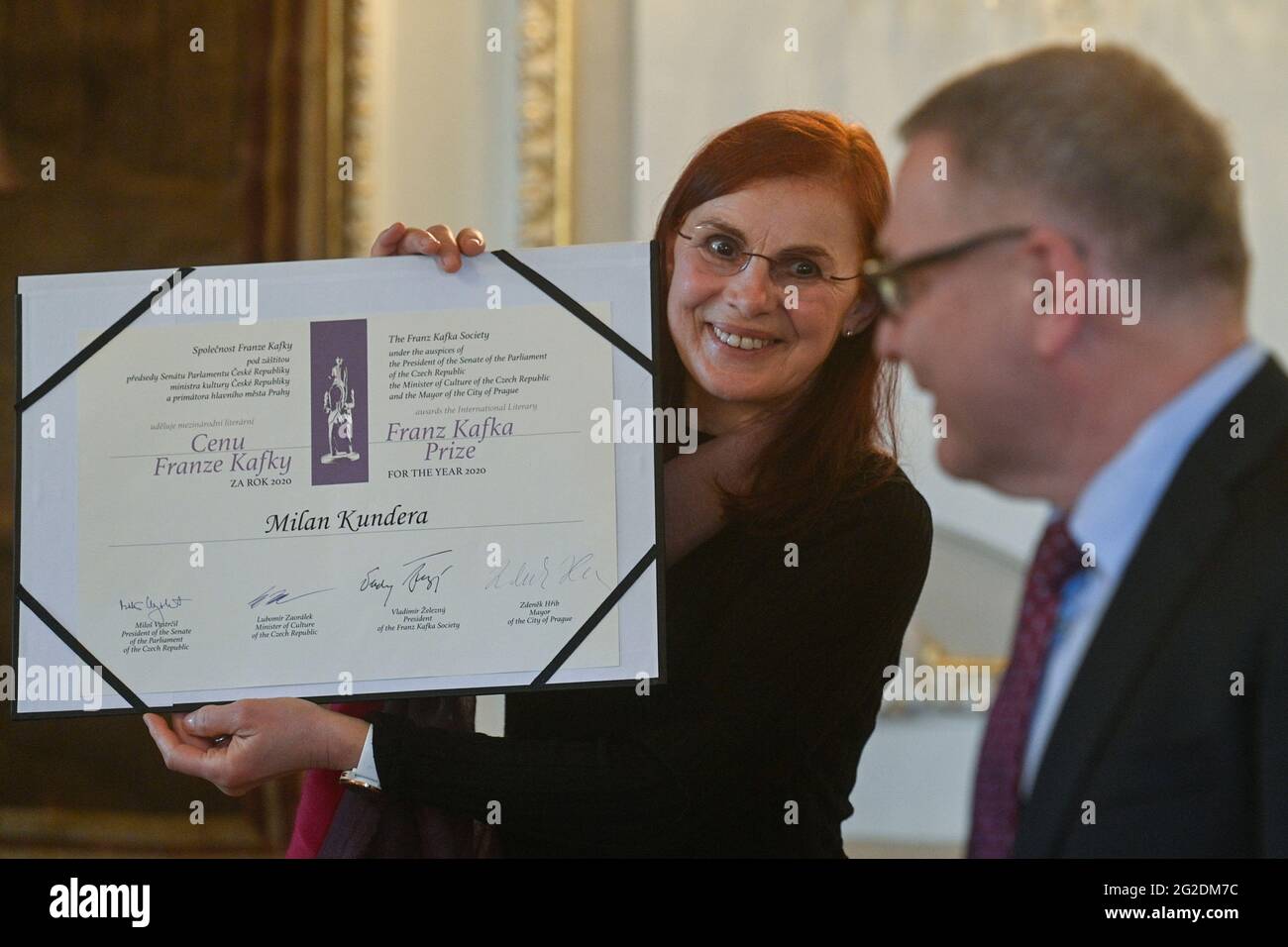 Prague, Czech Republic. 10th June, 2021. Translator from French to Czech  Anna Kareninova, left, receives the Franz Kafka Award for Czech author  living in France Milan Kundera at the French Embassy in