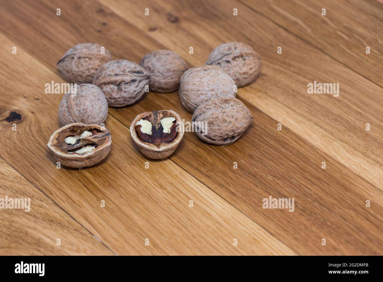 Stack Walnuts on wooden background. Walnut kernels close-up Stock Photo ...