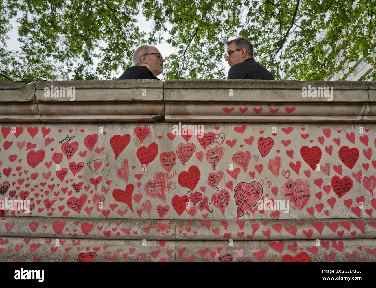 The National Covid Memorial Wall, a public mural painted by volunteers to commemorate victims of the COVID-19 pandemic in the United Kingdom. It is on the South Bank of the River Thames in London, opposite the Palace of Westminster, London, England, UK. Stock Photo