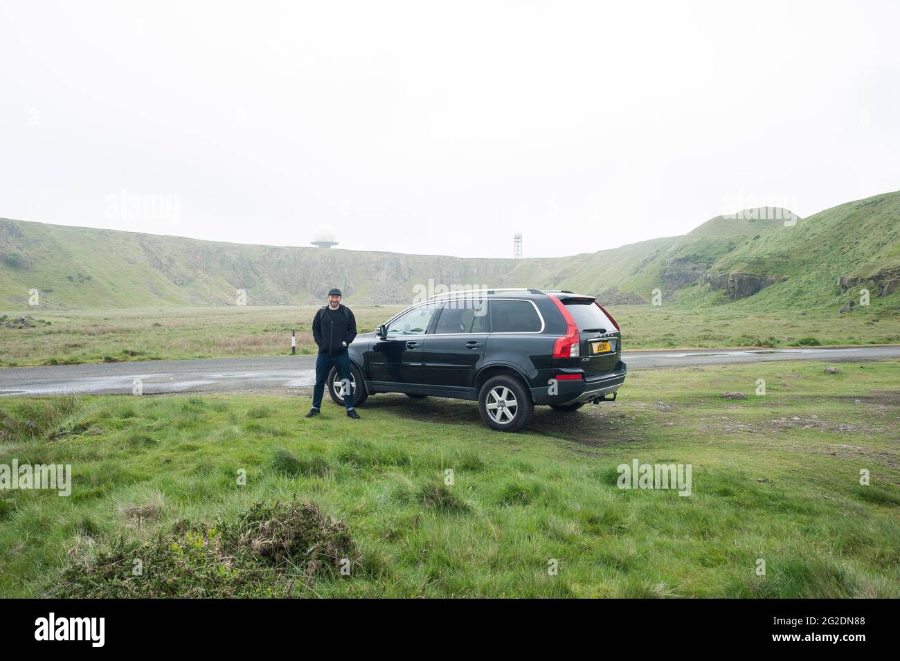 A man stands by his Volvo XC90 4x4 car in the landscape Stock Photo
