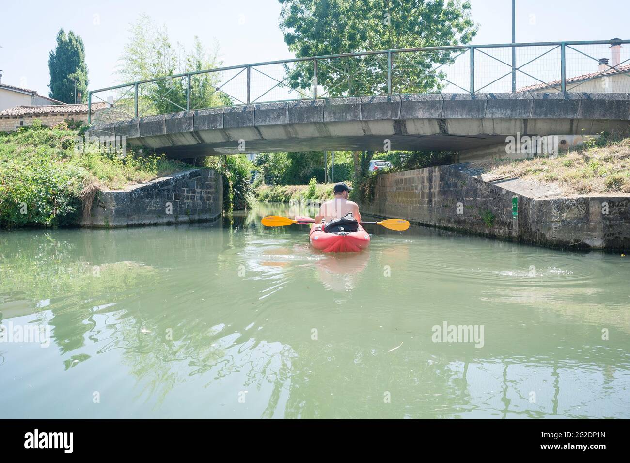 A family kayaks in Regional Natural Park of the Marais Poitevin on inflatable kayaks on a summer holiday in France Stock Photo