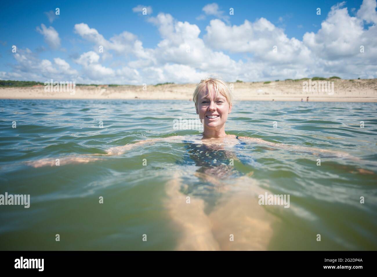 A person swimming in the water on holiday in France. Stock Photo