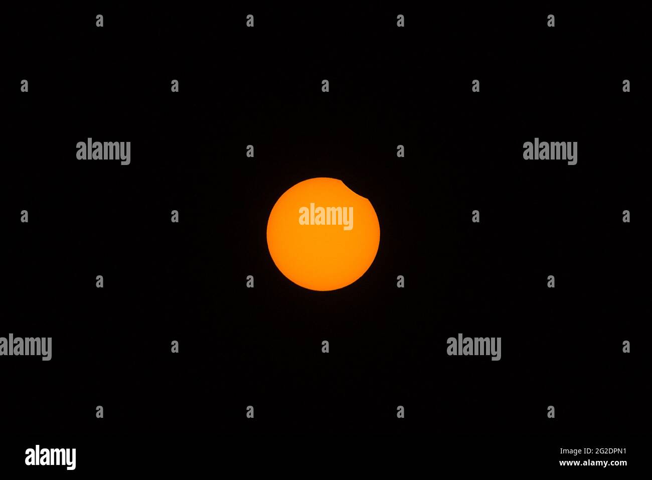 Beautiful centered view of partial (annular) eclipse visible in Irish skies on June 10, 2021, Dublin, Ireland. The beginning phase Stock Photo