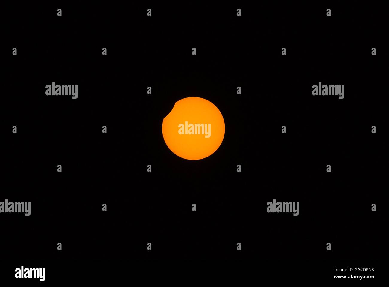 Beautiful centered view of partial (annular) eclipse visible in Irish skies on June 10, 2021, Dublin, Ireland. The end phase Stock Photo