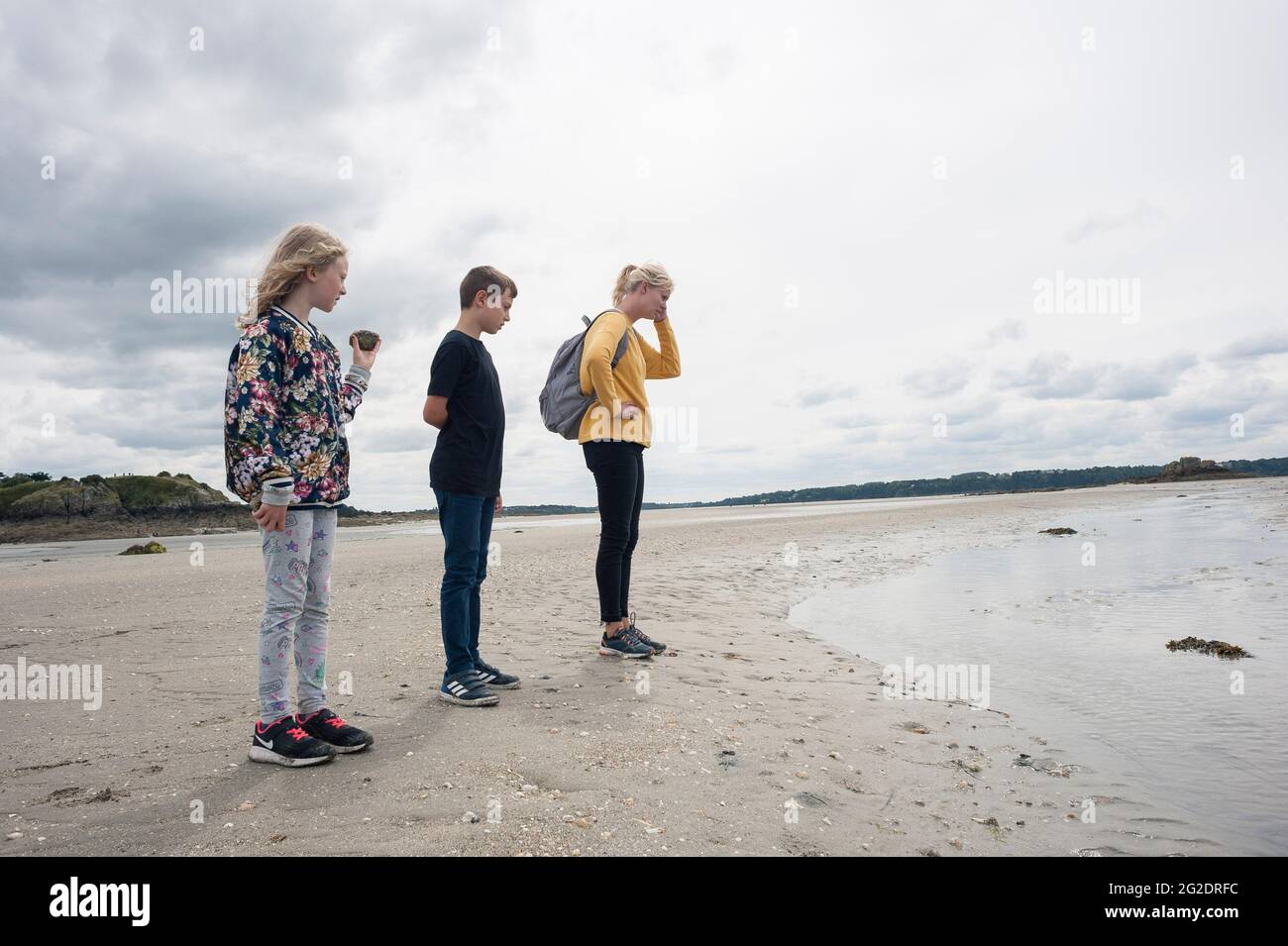 A family have a great day out exploring the beach and seaside in Brittany in Northern, France Stock Photo