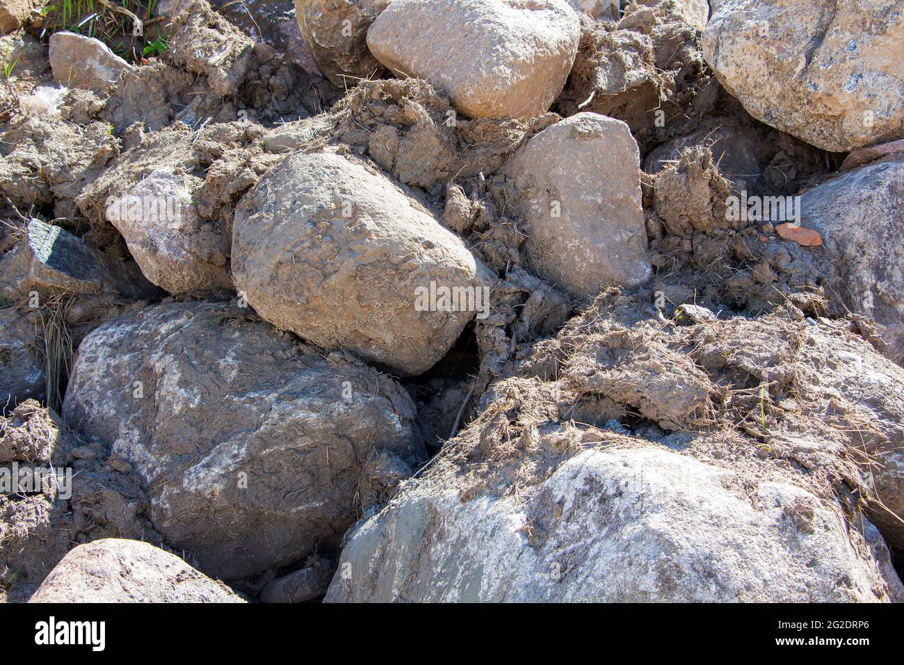 Rockfall on the road in the mountains. Stones of different sizes ...