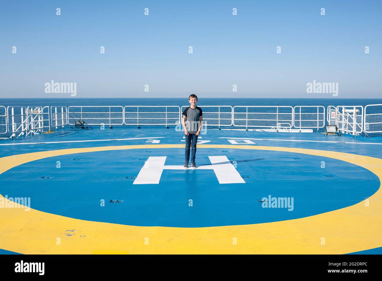 A child stands on the helicopter landing pad on the cross channel ferry Stock Photo Alamy