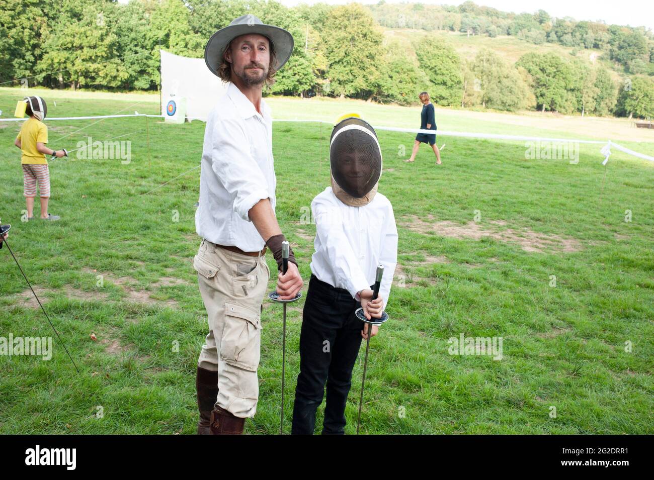 A boy tries sword fighting / fencing sport Stock Photo Alamy