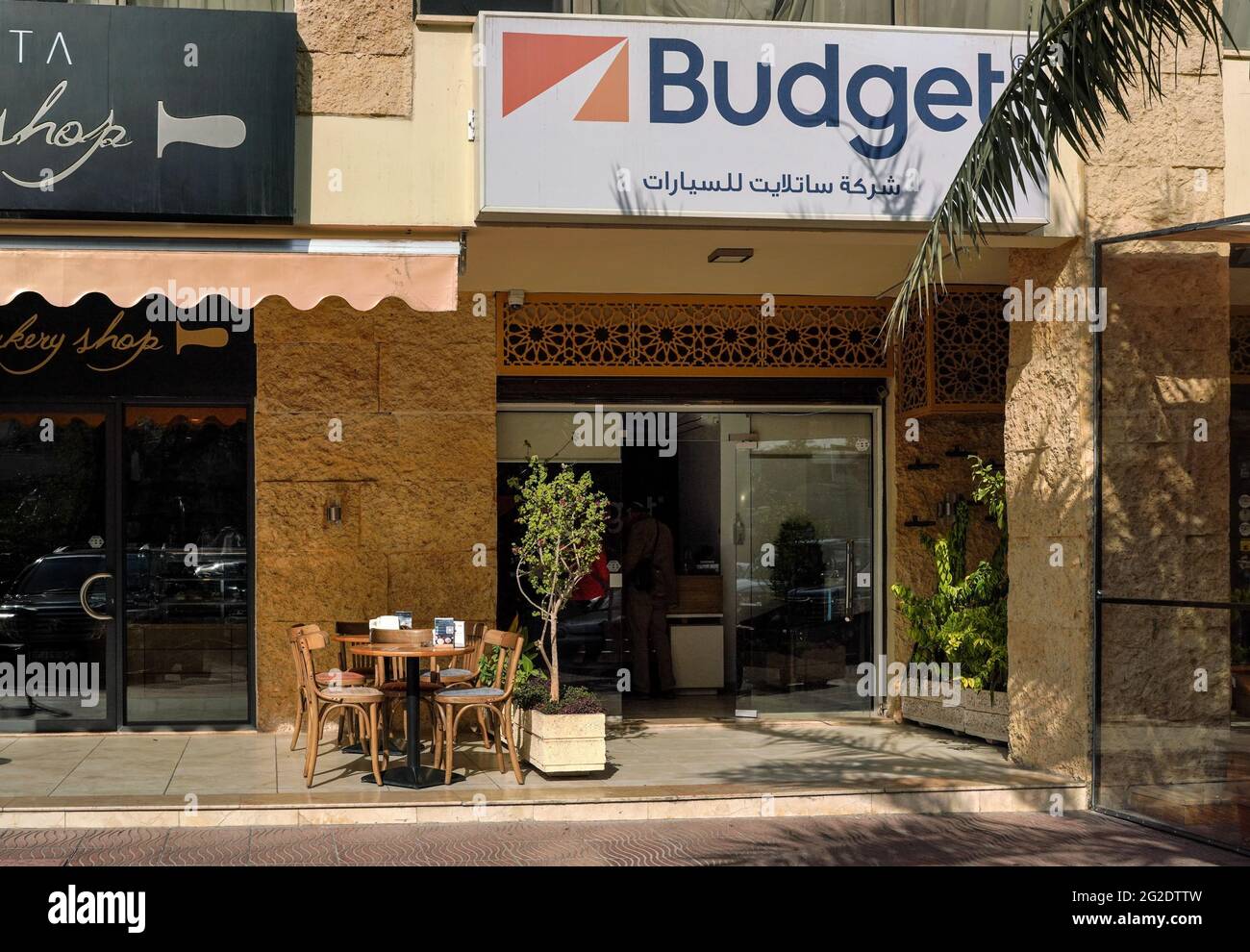 Aqaba, Jordan - January 21st, 2020: Budget logo with Arabic name below at entrance to one of their branches in Aqaba. It is American car rental compan Stock Photo