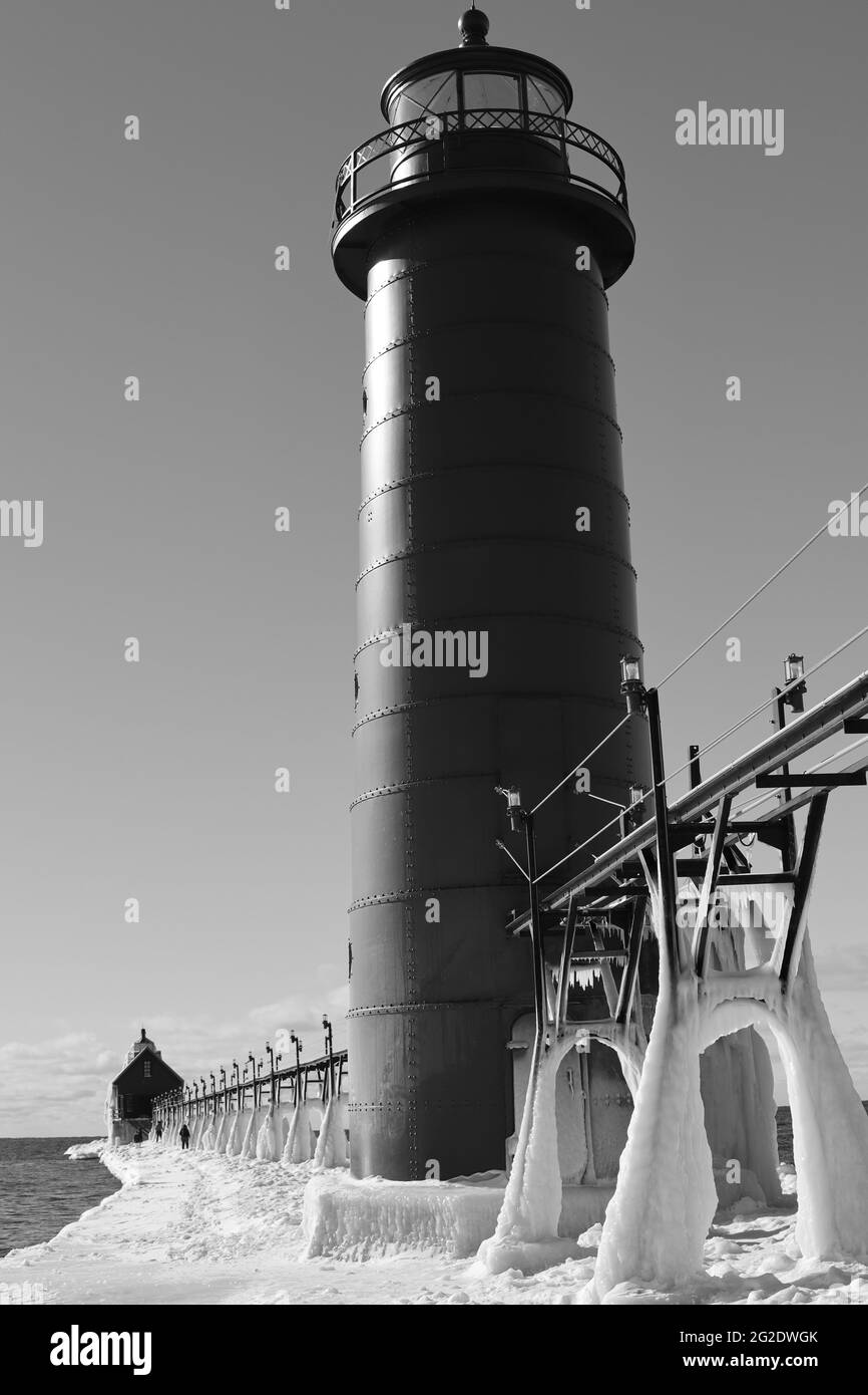 Grayscale vertical shot of grand haven lighthouse in winter in Michigan Stock Photo