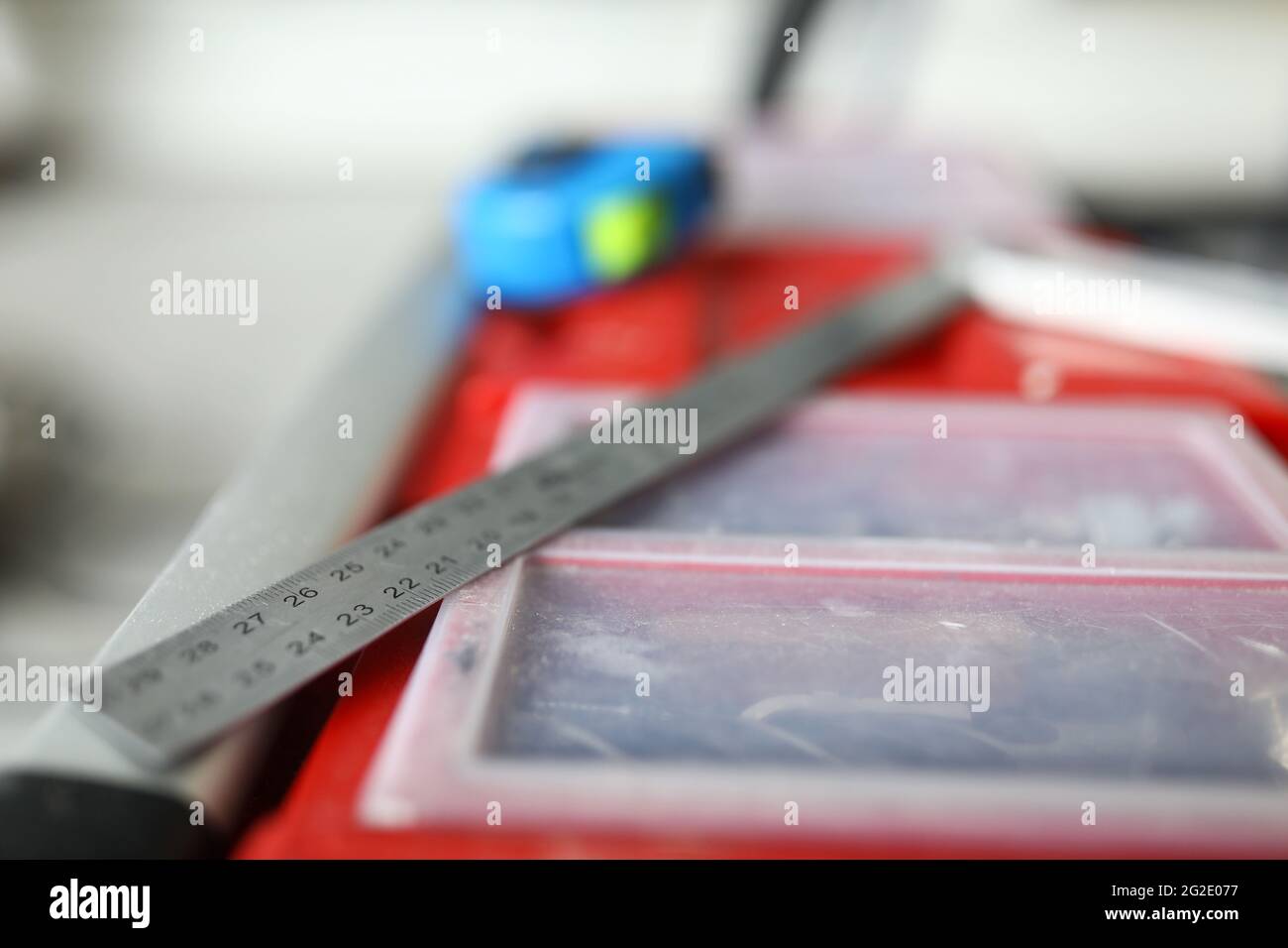 Close-up of metal ruler laying on red box with instruments Stock Photo ...