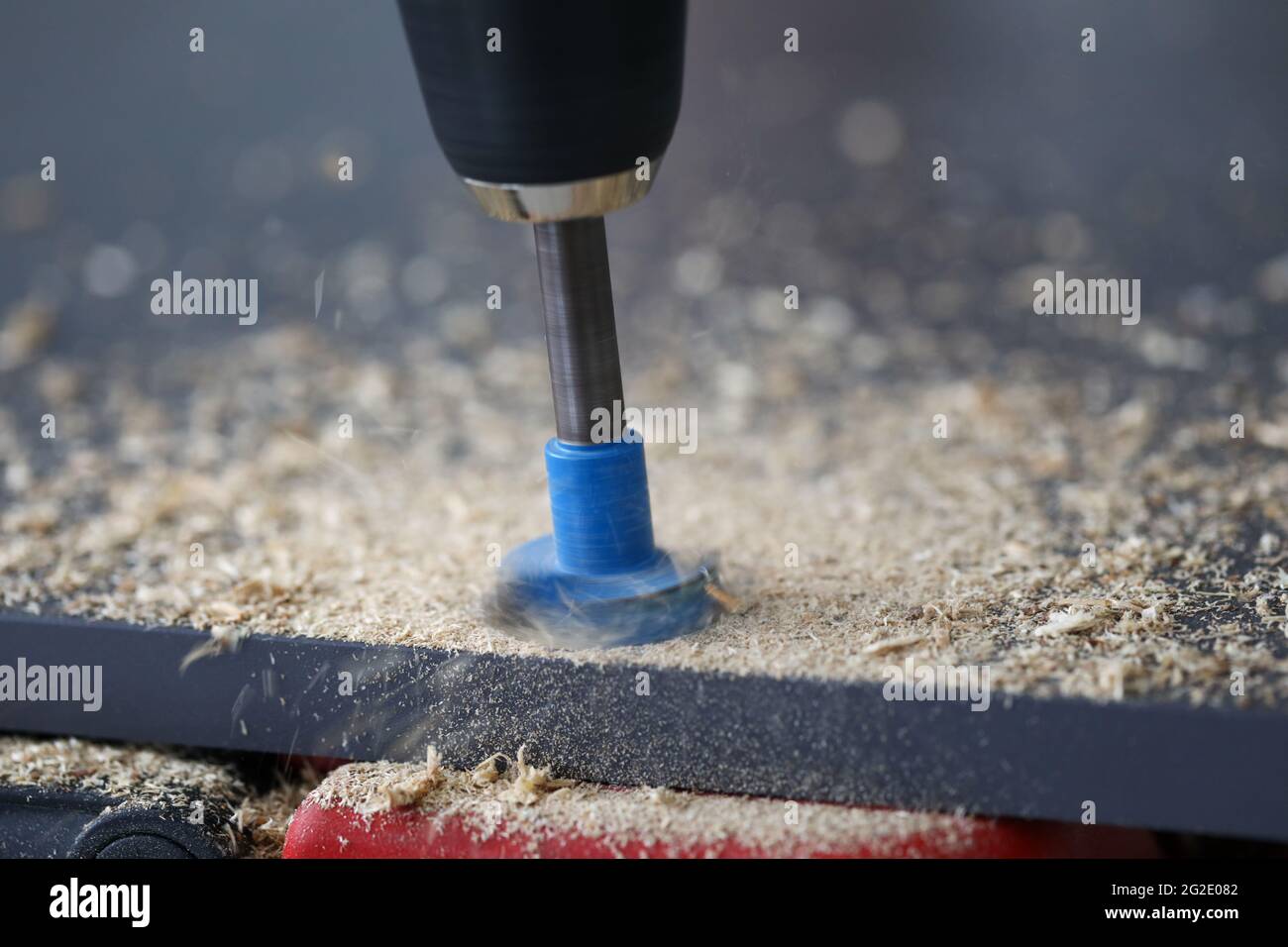 Drilling through holes in chipboard with a tool Stock Photo Alamy