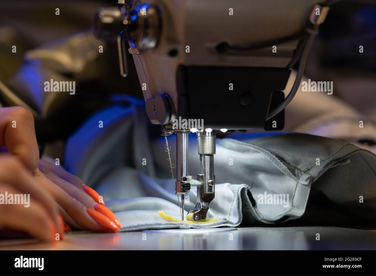 Seamstress work on sewing machine, closeup. Woman fashion designer