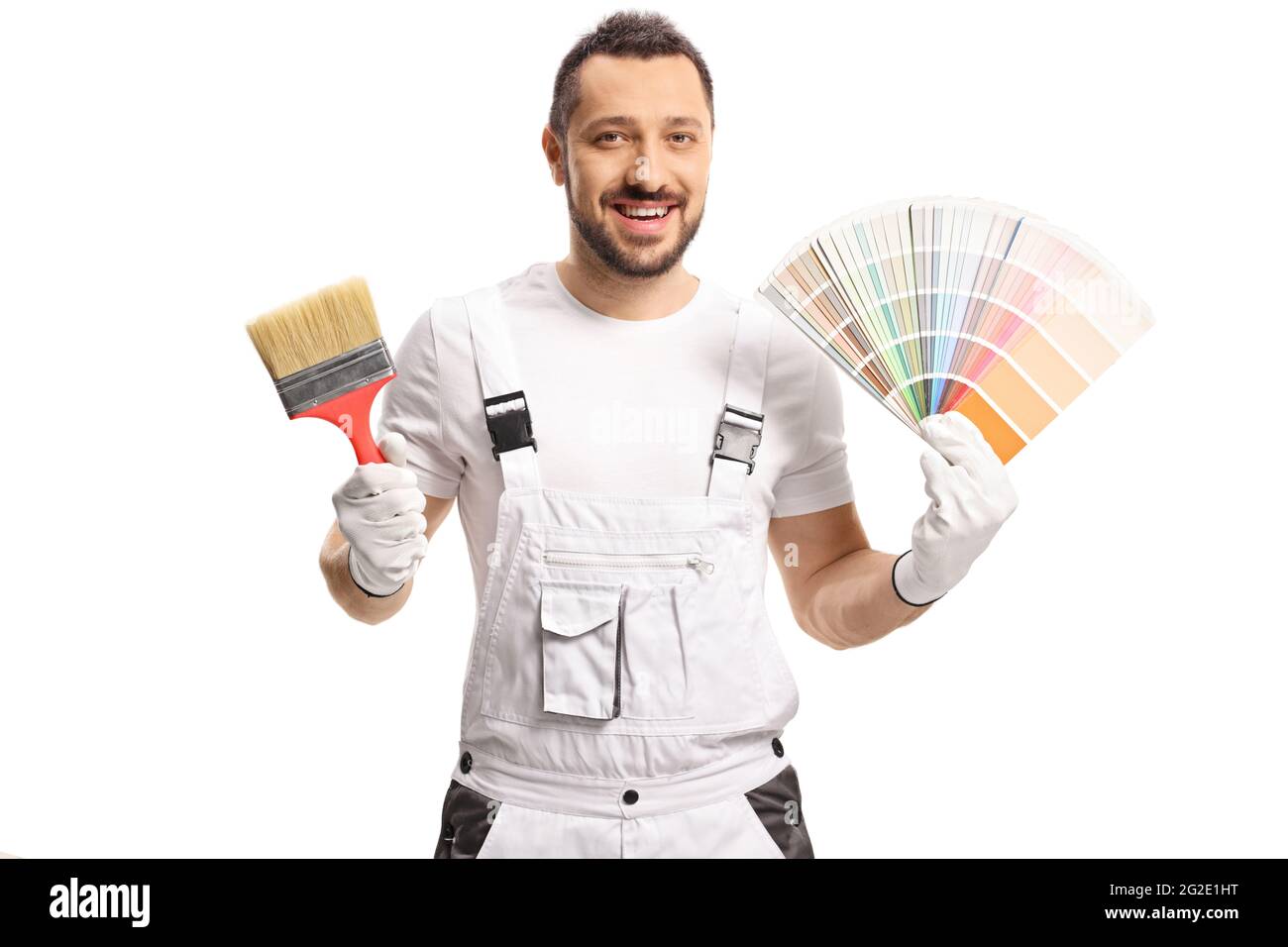 Painter in a white uniform holding a color palette and a brush isolated on white background Stock Photo